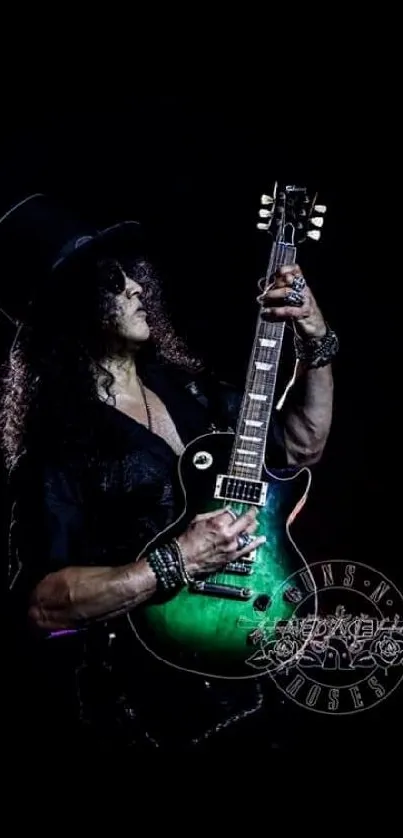 Iconic guitarist playing live with a green guitar on a dark stage.