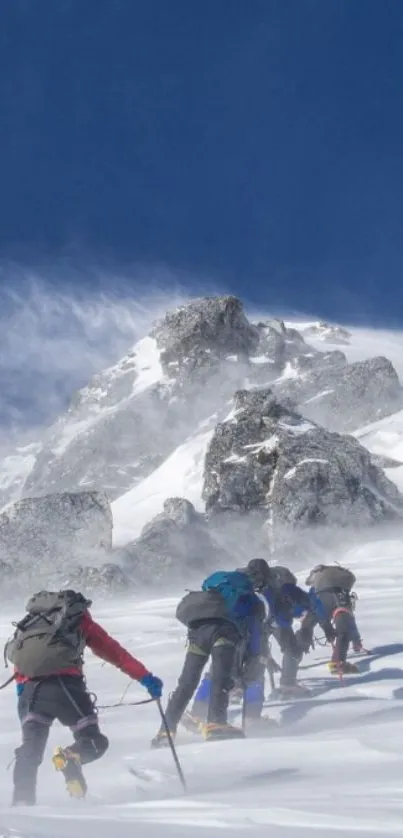 Climbers ascending a snowy mountain under a clear blue sky.