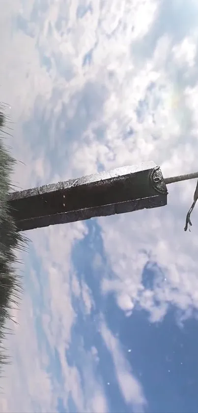 Epic sword under a bright blue sky with clouds.