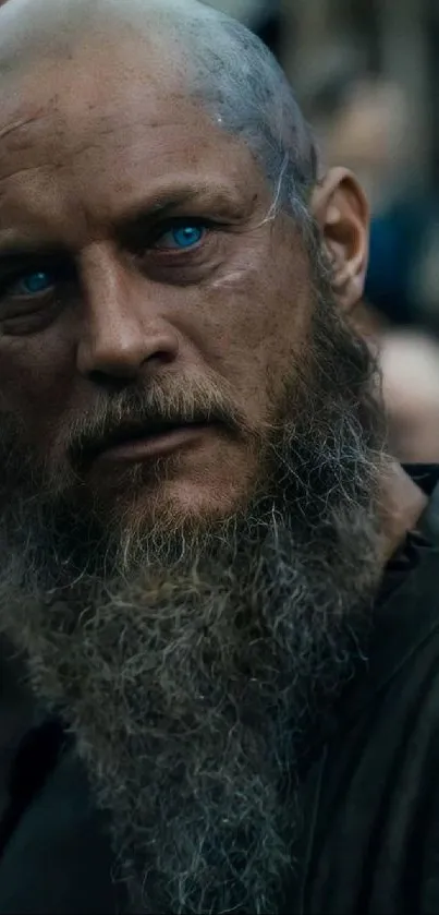 Warrior with blue eyes and beard in dramatic portrait.