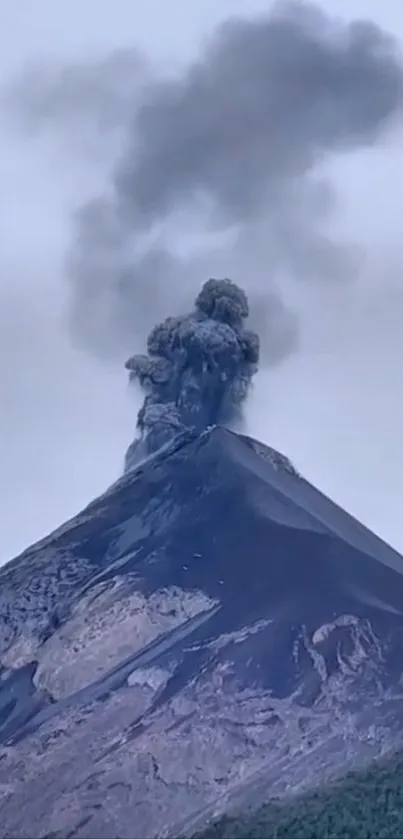 Volcano erupting with ash clouds against a gray sky, capturing natural drama.