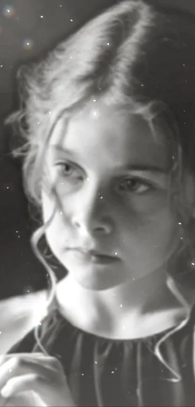 Black and white portrait of a young girl with a bokeh effect.