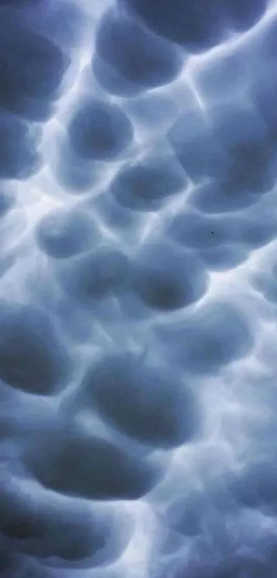 Ethereal cloudy sky mobile wallpaper with soft blue light.