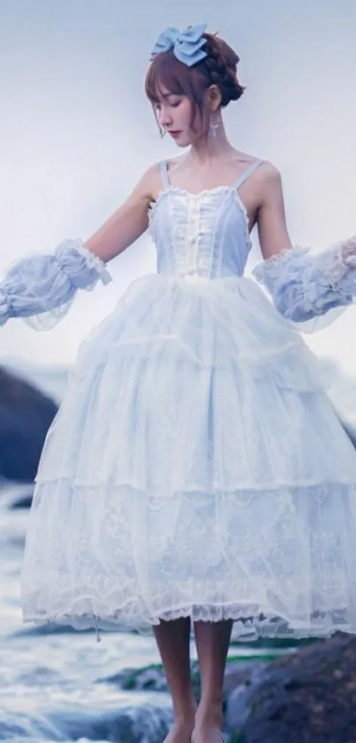 Gothic girl in white dress by the ocean, dreamy scene.