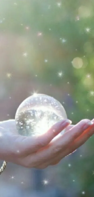 Hand holding a crystal sphere with sparkles and a mystical effect.