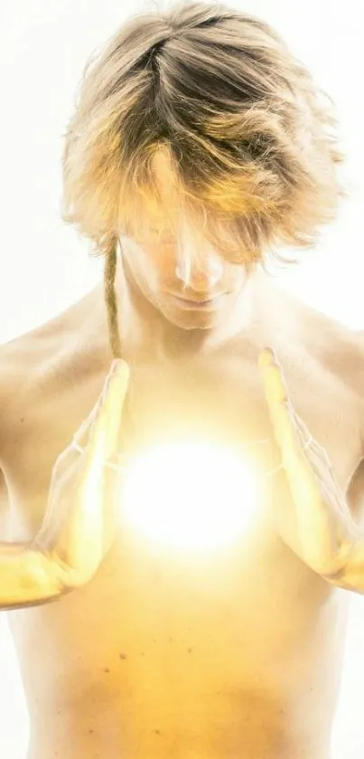 Person with glowing light between hands, creating a mystical effect.