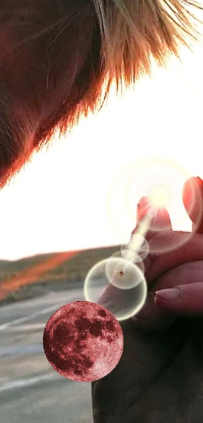 Surreal image of fingers reaching toward a glowing moon with a red tint.