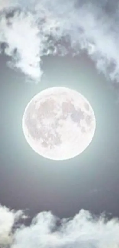 Full moon surrounded by clouds in a serene evening sky.