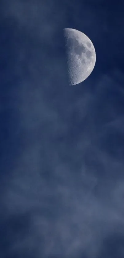 Half moon in a dark, cloudy night sky wallpaper.