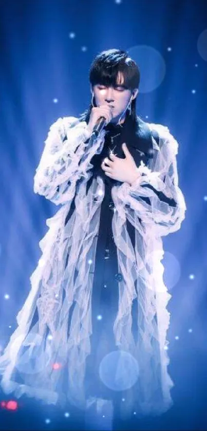 Singer in blue lighting on stage creating an ethereal and captivating visual moment.