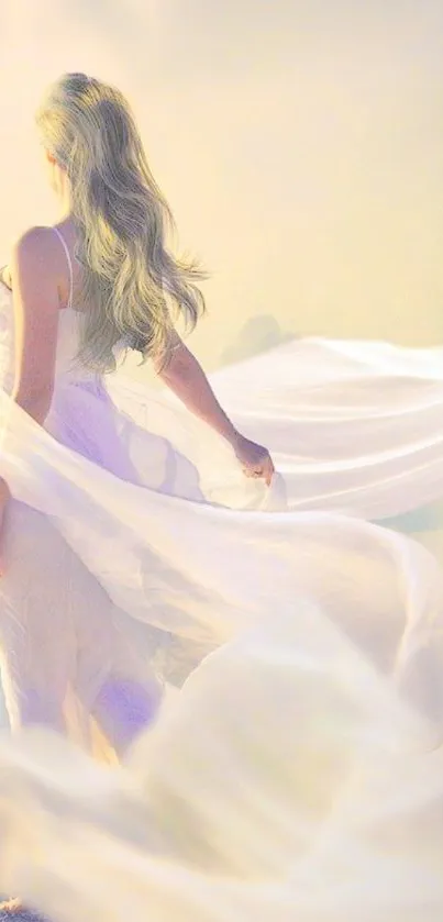 Woman in a flowing white dress against a dreamy sky background.