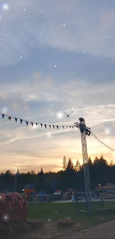 Evening festival scene with sunset, flags, and pumpkins.