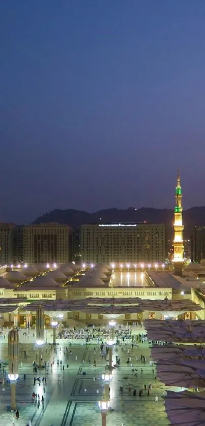 Evening cityscape with illuminated buildings and a dark blue sky.