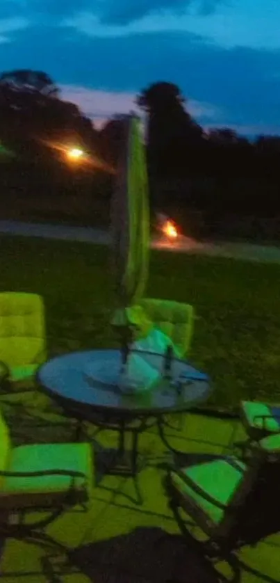 Nighttime patio scene with chairs and table under a dimly lit sky.