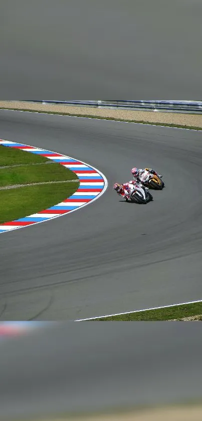 Motorcycle racers navigate a sharp track turn with speed and precision.