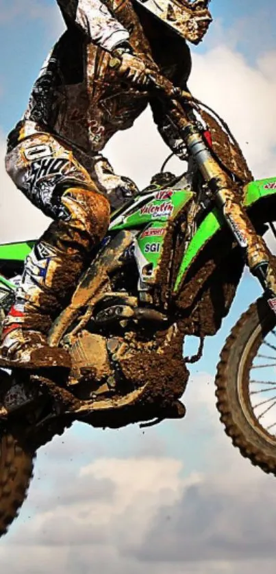 Dynamic motocross rider jumping high on a dirt bike against a cloudy sky.