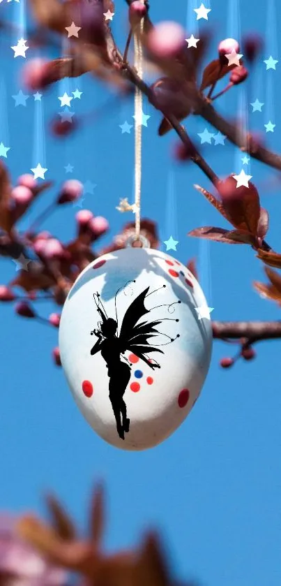 Fairy silhouette on an egg with blossoms against blue sky.