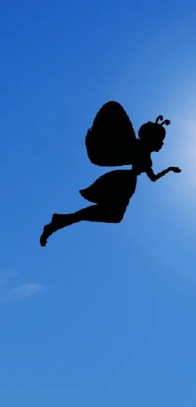 Silhouette of a fairy flying in a bright blue sky with a shining sun.