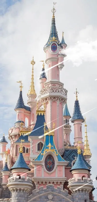 Fairytale pink castle with blue towers against a cloudy sky.