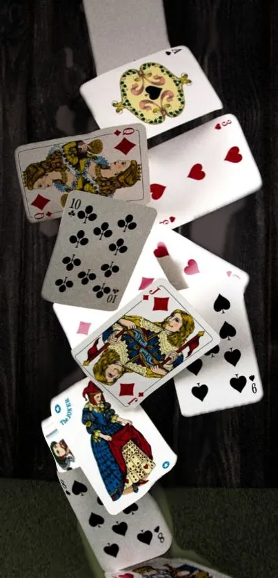 Falling playing cards on a dark wooden background.