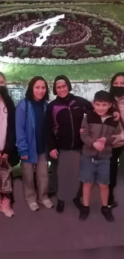 Family posing by a scenic flower clock.