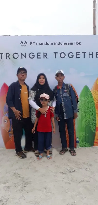 Family posing at a beach event with colorful surfboards.