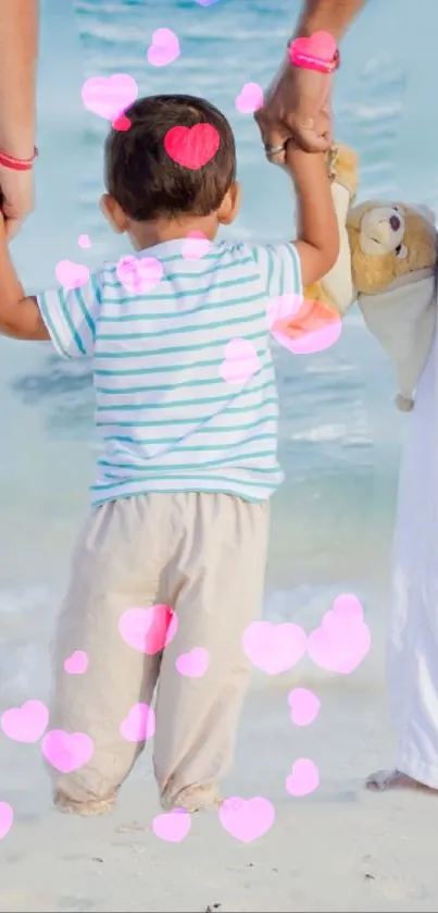 Child with parents on a beach, holding a teddy bear, with pink heart overlays.