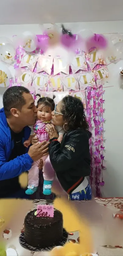 Family celebrating a birthday with cake and decorations.