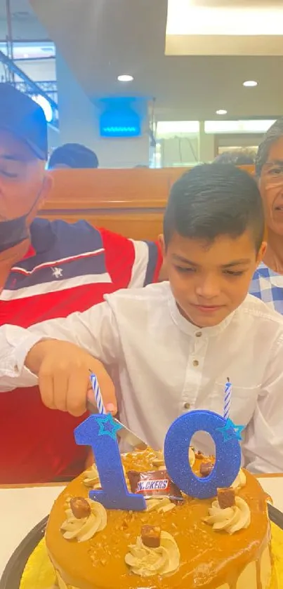 Family celebrating a tenth birthday with a cake.