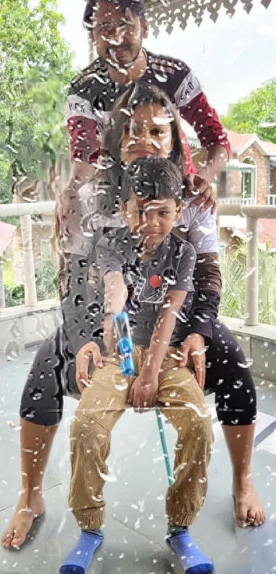 Family enjoying a rainy day on the balcony with water droplets.