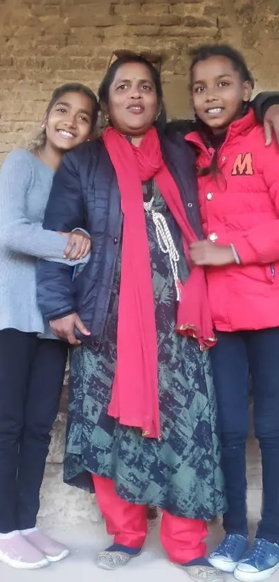 A family enjoying a warm bonding moment against a rustic wall.