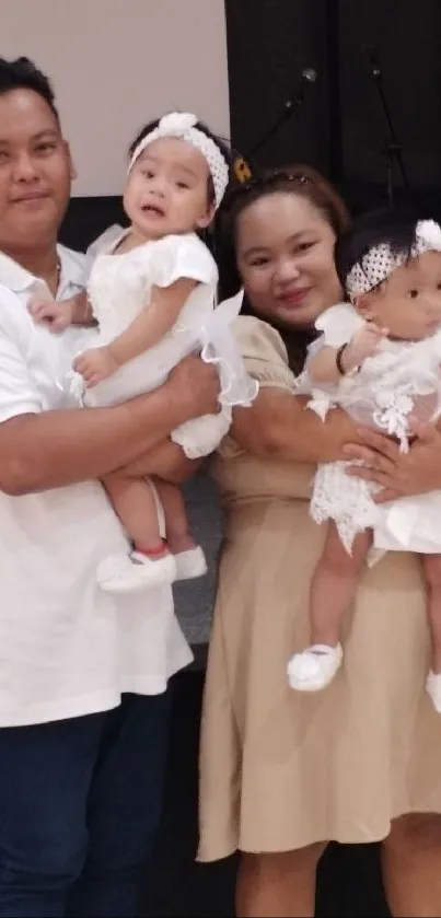 Parents holding children in a celebration scene.