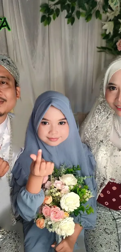 Smiling family in formal attire with floral backdrop.