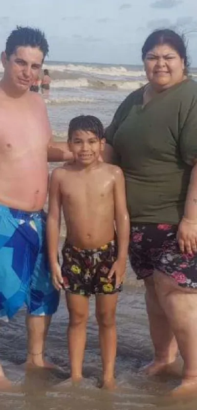 A family of three enjoying a day at the beach under clear skies.