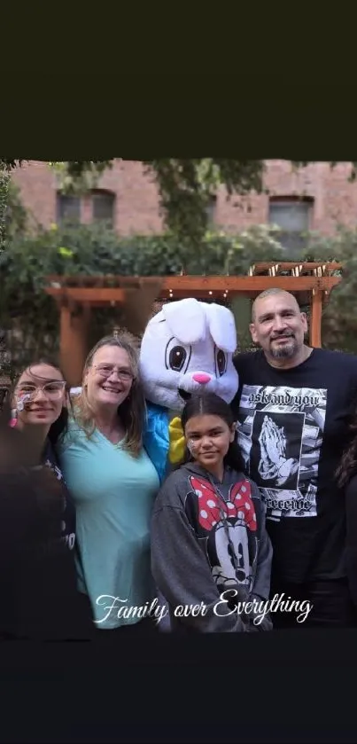 Smiling family with a mascot under trees.