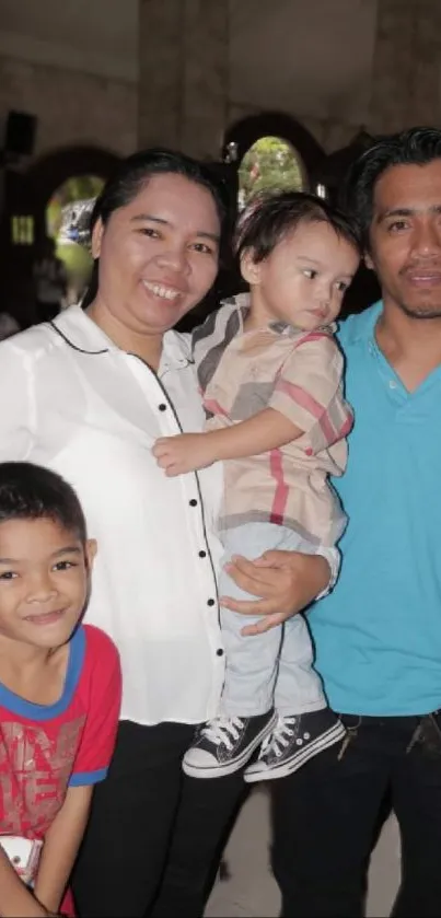 Smiling family gathered indoors for a heartfelt moment.