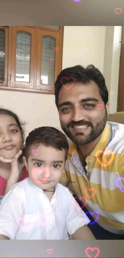 Family posing with hearts overlay on wallpaper.