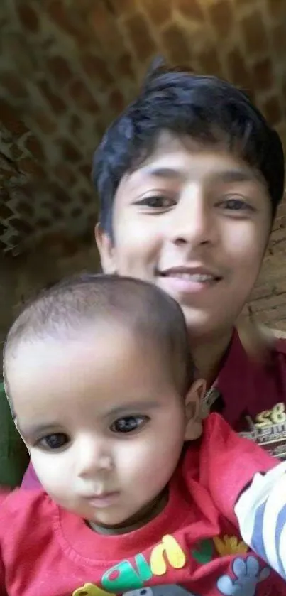 Smile with baby in front of a brick wall.