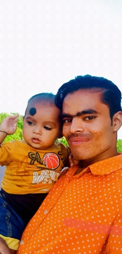 Father and child smiling outdoors with nature background.