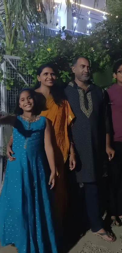 Family enjoying an outdoor evening gathering with lush greenery.