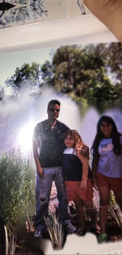 Family standing near a tranquil lake with lush greenery.