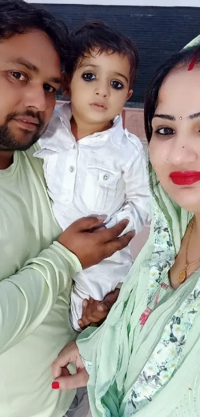 Family dressed in green and white, capturing a heartfelt moment.