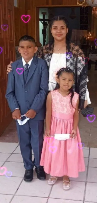 Family portrait in elegant attire outside a warmly lit entrance.