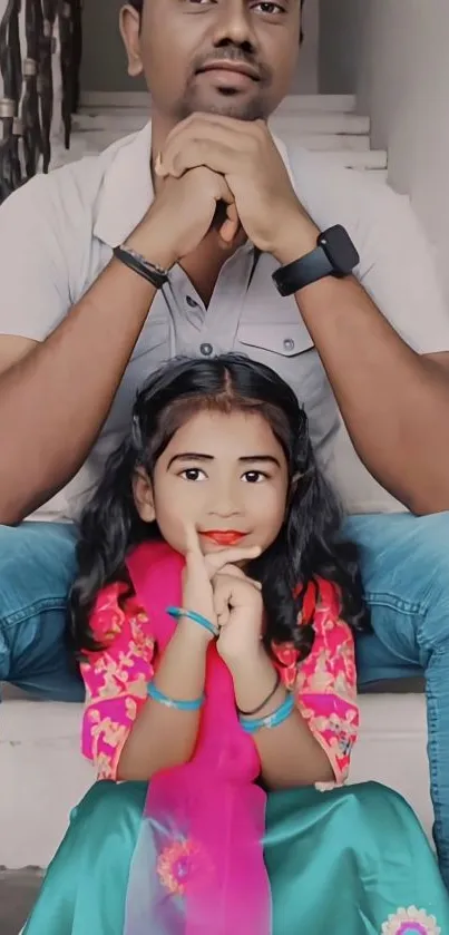 Father and daughter sit on stairs in a colorful family portrait wallpaper.