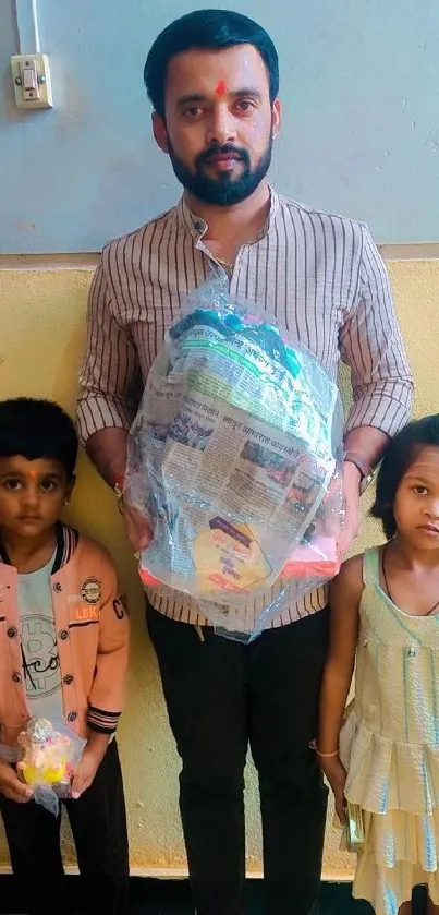 Family portrait with man and children holding a gift.