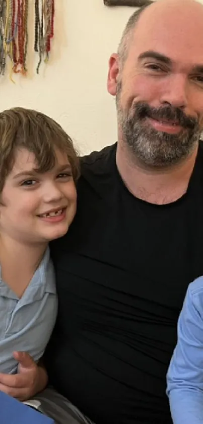 Father smiling with two young sons in a cozy family setting.