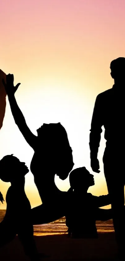 Family silhouette against a vibrant sunset at the beach.