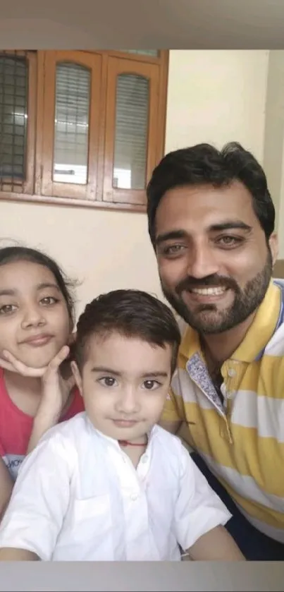 Smiling family with children and father captured in a warm, joyful moment.