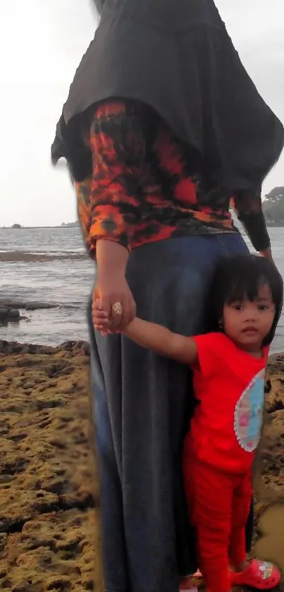 Mother and child walking on rocky beach.