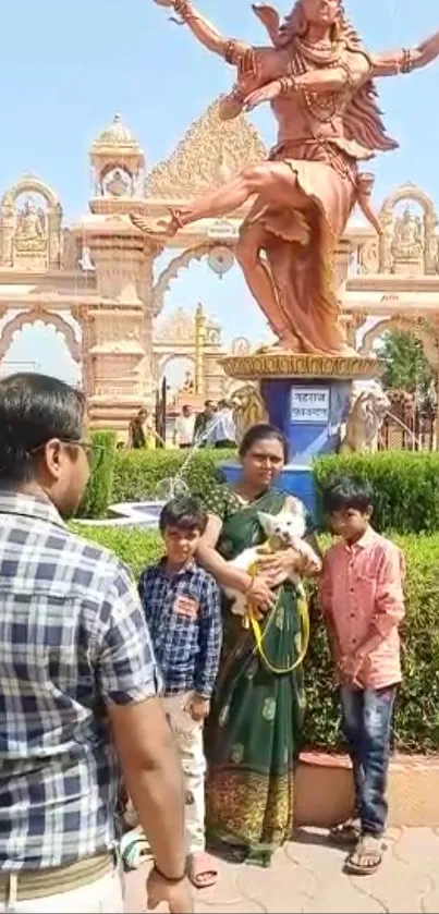 Family standing in a statue park, posing for a photo in front of a large sculpture.